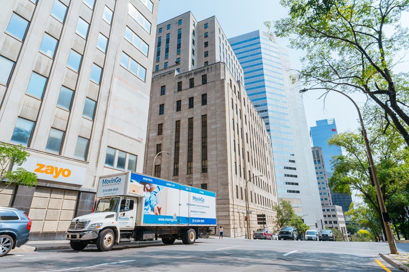 MovinGo moving truck in downtown Montreal business district