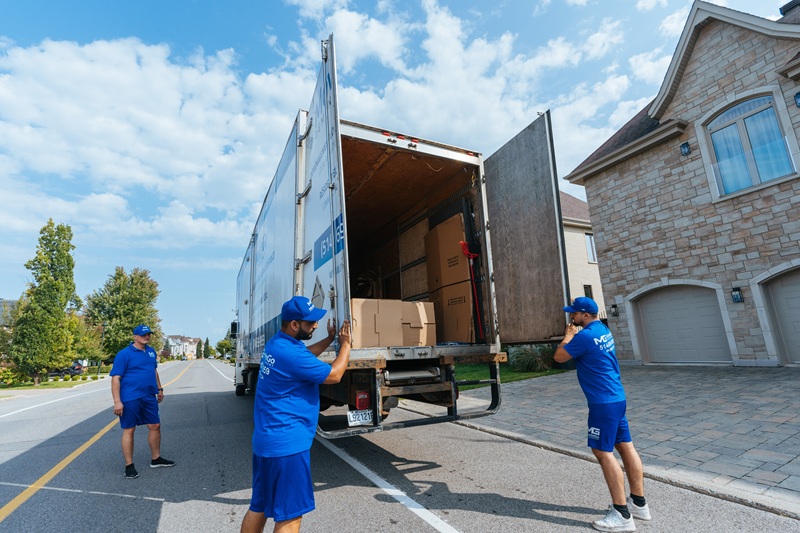 MovinGo movers preparing an open truck for residential unloading